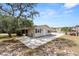 A single-story home with beige siding, dark shutters, and a concrete parking pad at 4070 Mcneil Rd, Apopka, FL 32703