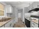 Efficient kitchen featuring bright cabinets, neutral countertops, and tiled floors at 4070 Mcneil Rd, Apopka, FL 32703