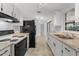 Well-lit kitchen with white cabinets, neutral countertops, and modern appliances offers ample space at 4070 Mcneil Rd, Apopka, FL 32703