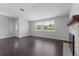 Inviting room boasts sleek hardwood floors, a cozy fireplace, and ample natural light from a large window at 4070 Mcneil Rd, Apopka, FL 32703