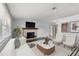 Bright living room featuring a brick fireplace, stylish furniture, and modern decor at 4070 Mcneil Rd, Apopka, FL 32703
