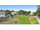 Aerial view showcasing the home with a tennis court, playground, and lush landscaping at 4199 Conway Place Cir, Orlando, FL 32812