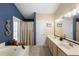 Bright bathroom featuring a large tub, double vanity, and a doorway leading to the outside, offering a spa-like experience at 4199 Conway Place Cir, Orlando, FL 32812