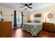 Bright bedroom featuring hardwood floors, and a large window offering ample natural light, creating a serene and comfortable retreat at 4199 Conway Place Cir, Orlando, FL 32812