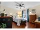 Bright bedroom with hardwood floors, a ceiling fan, natural light and comfortable furnishings create a welcoming and relaxing space at 4199 Conway Place Cir, Orlando, FL 32812