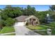 Charming single Gathering home featuring a two-car garage, lovely landscaping, and a welcoming entryway at 4199 Conway Place Cir, Orlando, FL 32812