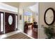 Inviting foyer with tile flooring, leading to a dining area with wood floors and large windows at 4199 Conway Place Cir, Orlando, FL 32812