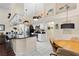 Bright kitchen with white cabinets, black countertops, a breakfast bar, and an adjacent dining area at 4199 Conway Place Cir, Orlando, FL 32812