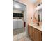 Practical laundry room featuring a washer, dryer, shelving, and a sink, with a view of the adjacent bathroom creating efficiency at 4199 Conway Place Cir, Orlando, FL 32812