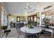 A spacious screened-in patio with ceiling fans, comfortable seating, dining, and a sink at 4199 Conway Place Cir, Orlando, FL 32812