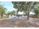 Exterior of home with white paint, view of the screened porch, and fenced backyard at 451 E 5Th St, Chuluota, FL 32766
