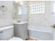 Bathroom with white marble tile, shower and tub at 451 E 5Th St, Chuluota, FL 32766
