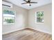Bright bedroom with ceiling fan and ample natural light from two windows at 451 E 5Th St, Chuluota, FL 32766