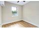 Bedroom with mini-split air conditioner and large window at 451 E 5Th St, Chuluota, FL 32766