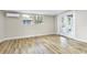 Bright bedroom featuring wood-look flooring, neutral walls, and french doors to outside at 451 E 5Th St, Chuluota, FL 32766
