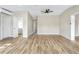 Spacious bedroom featuring hardwood floors, a ceiling fan, and ample closet space at 451 E 5Th St, Chuluota, FL 32766