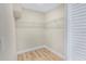 A walk-in closet features wood-look flooring and wire shelving at 451 E 5Th St, Chuluota, FL 32766