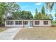 Charming single-story home with light blue door and gray shutters at 451 E 5Th St, Chuluota, FL 32766