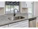 Kitchen with stainless steel dishwasher, granite countertops, and white cabinets at 451 E 5Th St, Chuluota, FL 32766