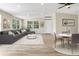 Open-concept living area with large windows and a modern aesthetic at 451 E 5Th St, Chuluota, FL 32766