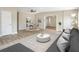 Spacious living room with light wood floors, dining area, and modern decor at 451 E 5Th St, Chuluota, FL 32766