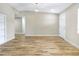 Inviting living room featuring hardwood floors, a modern light fixture, and a white door at 451 E 5Th St, Chuluota, FL 32766