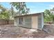 Exterior of outbuilding featuring a simple door and one window at 451 E 5Th St, Chuluota, FL 32766
