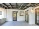 Spacious screened porch with grey floors and view to the kitchen at 451 E 5Th St, Chuluota, FL 32766