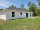 The backyard features a concrete patio and newly installed grass with a stunning view of the scenery at 4529 Sw 169Th Pl, Ocala, FL 34473
