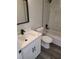 Bathroom featuring a shower/tub combo with a marble tile surround, white vanity and black fixtures at 4529 Sw 169Th Pl, Ocala, FL 34473