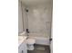 Hall bath featuring a shower/tub combo with a marble tile surround, white vanity and black fixtures at 4529 Sw 169Th Pl, Ocala, FL 34473
