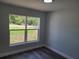 Bedroom featuring gray walls, LVP flooring, and a large window at 4529 Sw 169Th Pl, Ocala, FL 34473