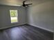 Bedroom with gray walls, LVP flooring, and a window view of the backyard at 4529 Sw 169Th Pl, Ocala, FL 34473