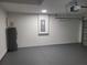 This spacious garage features a gray sealed floor, ample lighting, and a water heater at 4529 Sw 169Th Pl, Ocala, FL 34473