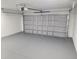 This spacious garage features a gray sealed floor, ample lighting, and an automatic garage door at 4529 Sw 169Th Pl, Ocala, FL 34473