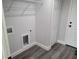 This spacious laundry room features gray wood laminate flooring and a convenient storage area at 4529 Sw 169Th Pl, Ocala, FL 34473
