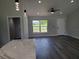 Bright living room with gray walls, ceiling fan, luxury vinyl flooring and a view of the front yard at 4529 Sw 169Th Pl, Ocala, FL 34473