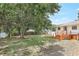 Backyard view featuring a deck with wooden stairs and a large tree at 4922 Huppel Ave, Orlando, FL 32811