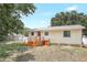 Home's backyard featuring a deck with wooden stairs and a lawn at 4922 Huppel Ave, Orlando, FL 32811