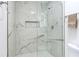 Beautifully tiled walk-in shower with glass doors and decorative niche at 4922 Huppel Ave, Orlando, FL 32811