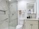 Renovated bathroom with a walk-in shower, sleek fixtures, and a lighted mirror over the vanity at 4922 Huppel Ave, Orlando, FL 32811
