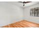 Bright bedroom features a ceiling fan and gleaming hardwood floors at 4922 Huppel Ave, Orlando, FL 32811