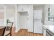 Convenient laundry setup integrated into the kitchen with white cabinets and modern appliances at 4922 Huppel Ave, Orlando, FL 32811