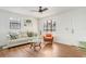 Well-lit living area with hardwood floors, neutral paint, and a comfortable seating arrangement at 4922 Huppel Ave, Orlando, FL 32811