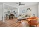 Bright living room featuring hardwood floors, recessed lighting, and an open layout to the kitchen and dining area at 4922 Huppel Ave, Orlando, FL 32811