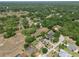 Aerial view showing a home with a manicured lawn, screened lanai, and natural surroundings, with a yellow star highlighting subject at 525 Hebrides Ct, Apopka, FL 32712