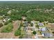 Wide aerial perspective featuring various homes among green trees and foliage, one highlighted with a yellow star at 525 Hebrides Ct, Apopka, FL 32712