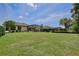 Large backyard with lush green grass and a glimpse of the home's lanai at 525 Hebrides Ct, Apopka, FL 32712