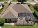 Aerial view of a home highlighting a screened lanai with a spa, and a well-kept backyard with manicured landscaping at 525 Hebrides Ct, Apopka, FL 32712