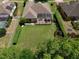 Aerial view of a lush backyard with a screened lanai, privacy hedges, and a well-maintained lawn at 525 Hebrides Ct, Apopka, FL 32712